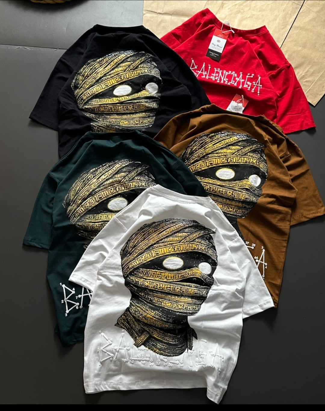 casual t-shirts featuring a graphic print of a mummy head, often sold as part of streetwear or fashion collections in India(PACK OF 3)