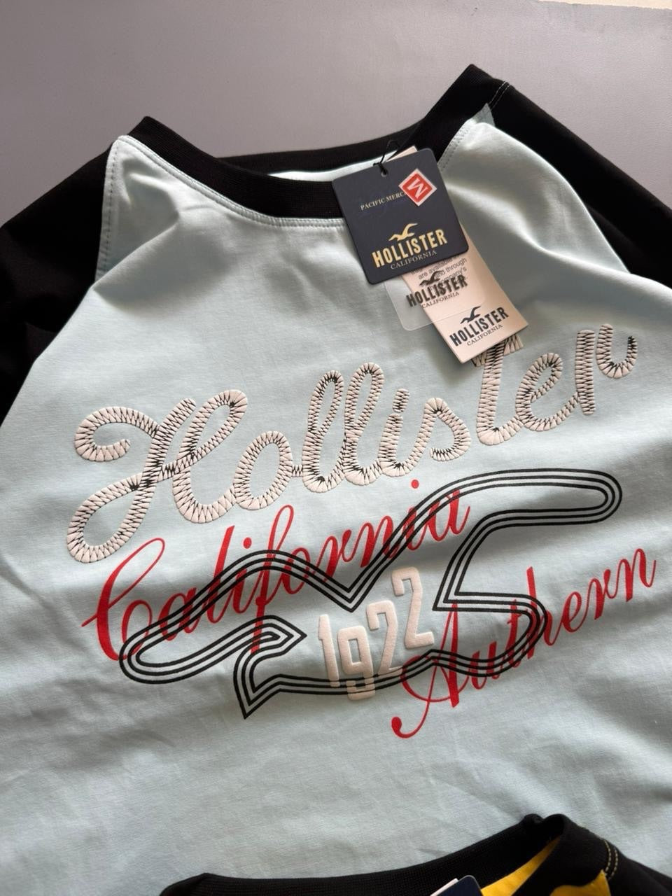 Hollister Co. colorblock logo graphic tees, featuring raglan sleeves and various California-inspired graphic (PACK OF 3)