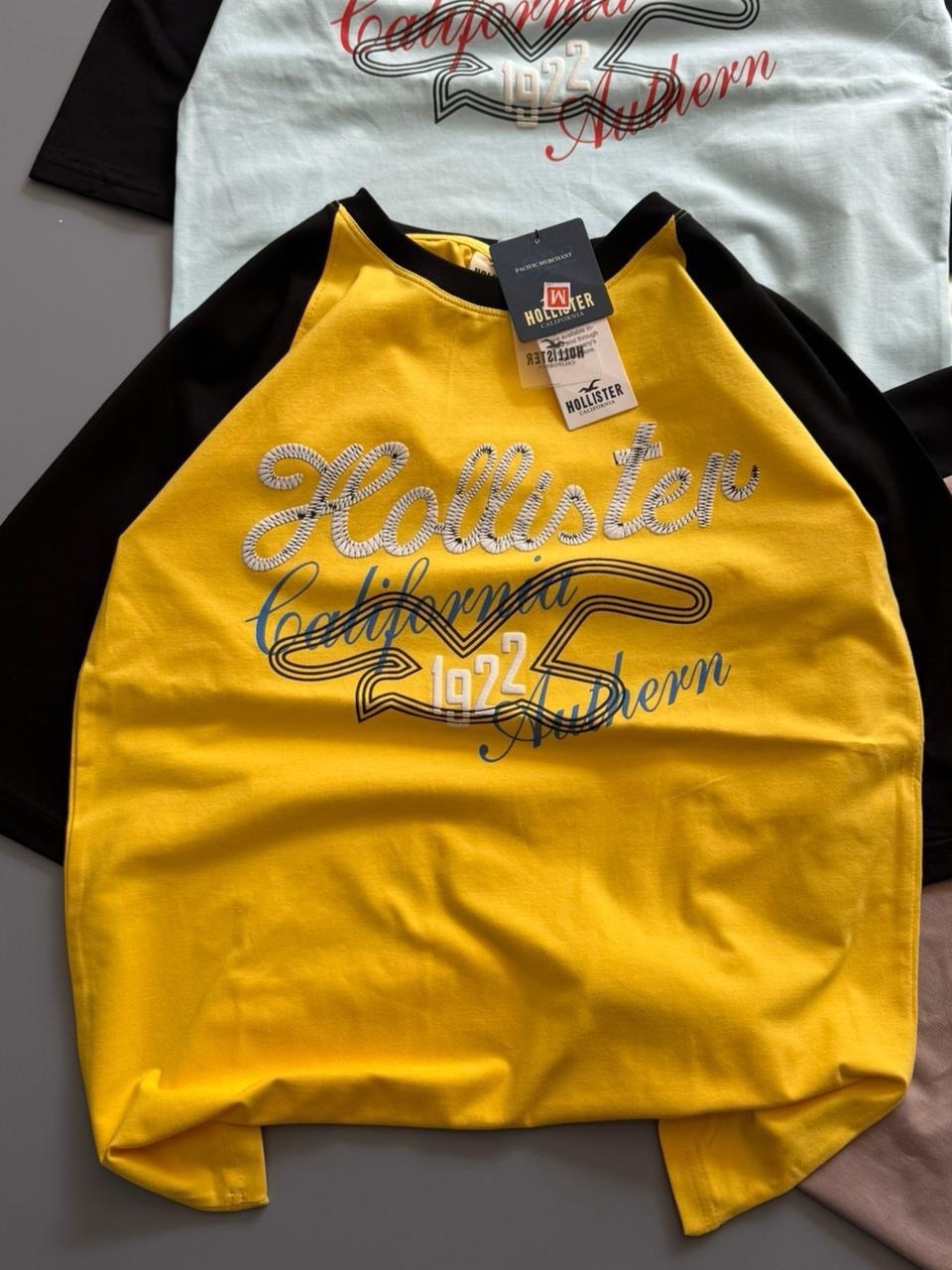 Hollister Co. colorblock logo graphic tees, featuring raglan sleeves and various California-inspired graphic (PACK OF 3)